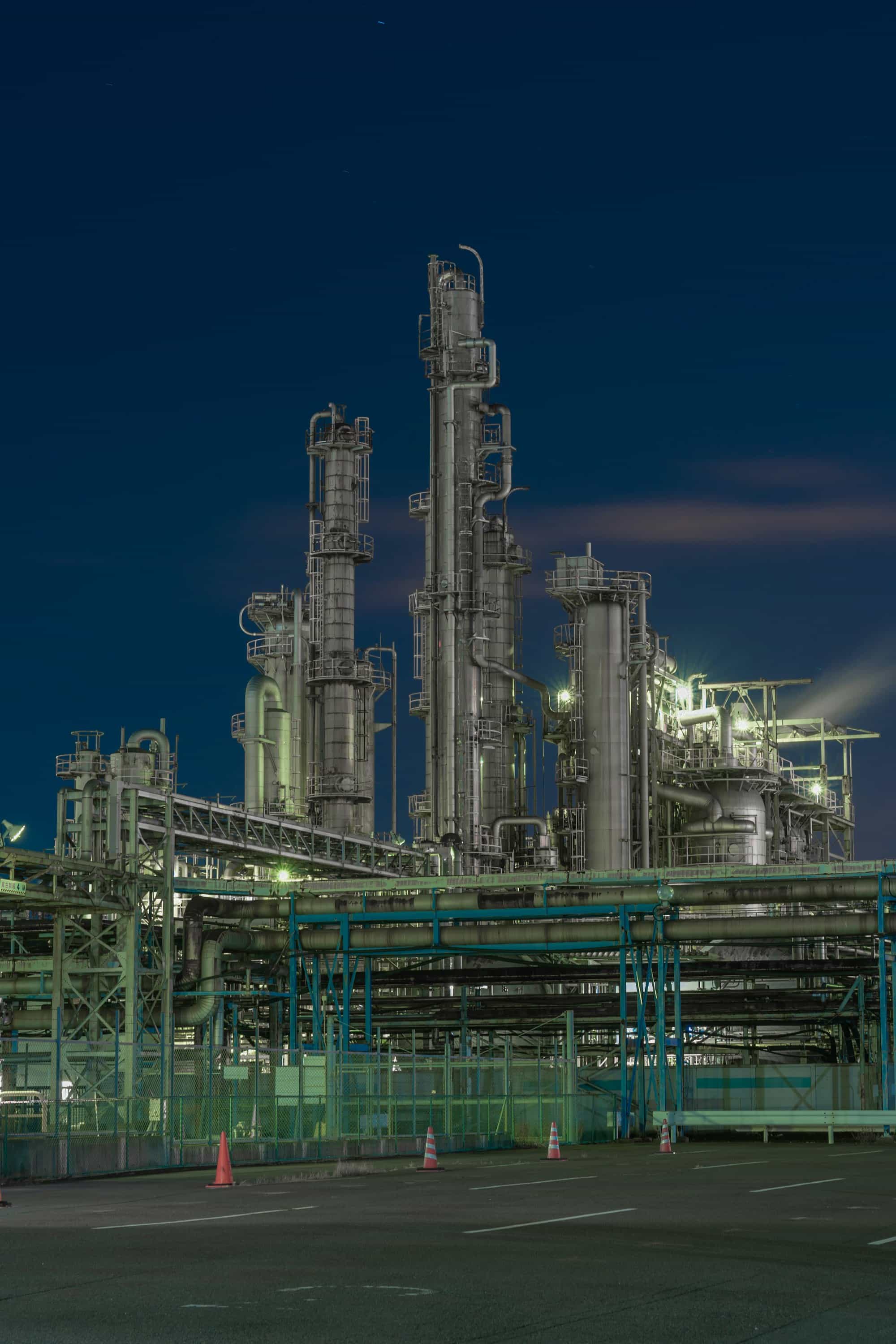 Illuminated industrial pipework at night
